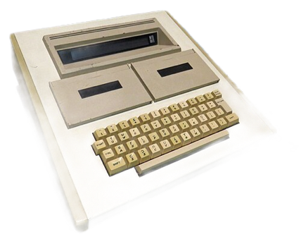 A vintage MCM/70 computer with a beige keyboard and two cassette drives on the top, placed on a table.