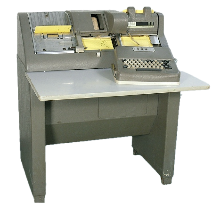 A vintage mechanical card punch machine with a keyboard and paper feed, set on a metal desk.