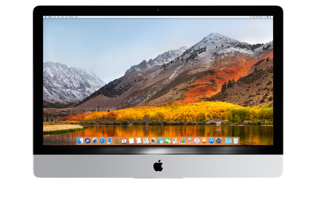 A desktop iMac 2011 computer with a silver base displaying a mountain landscape on the screen.